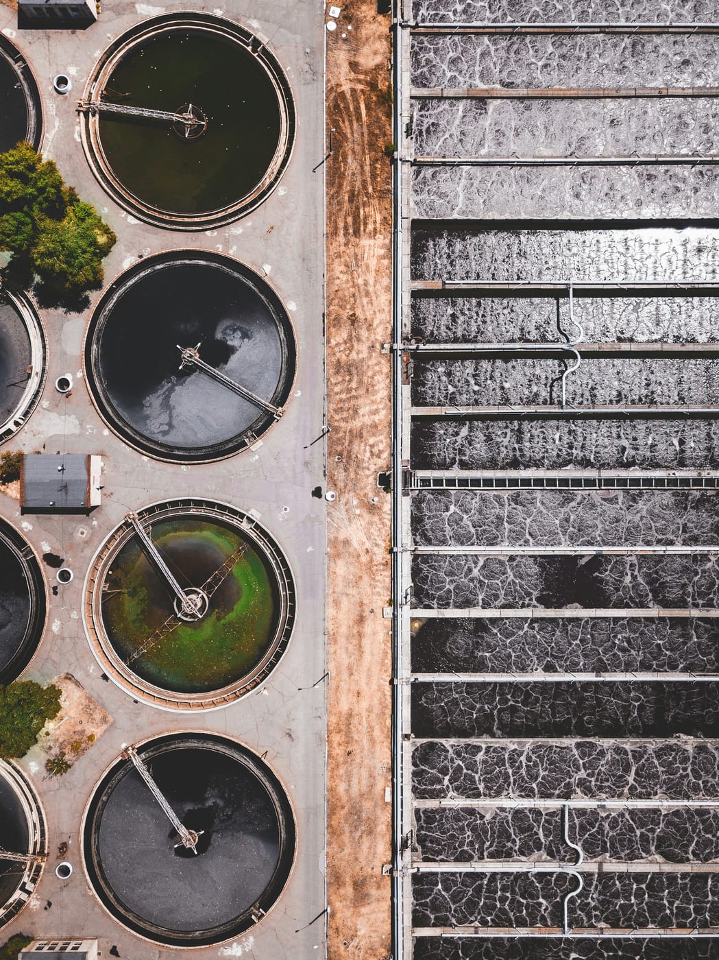 Aerial view of circular clarifiers and filtration beds at a wastewater treatment plant